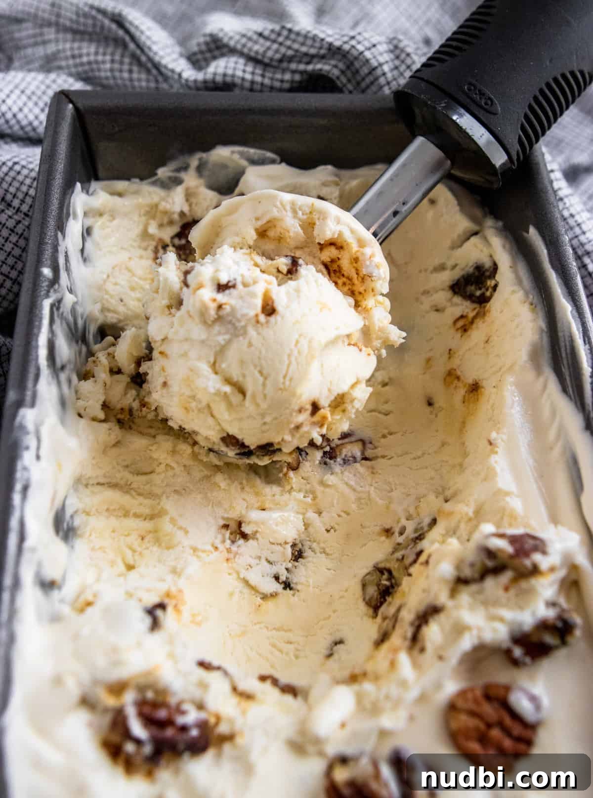 Homemade Butter Pecan Ice Cream Recipe You'll Love 3 No churn butter pecan ice cream scooped in container.