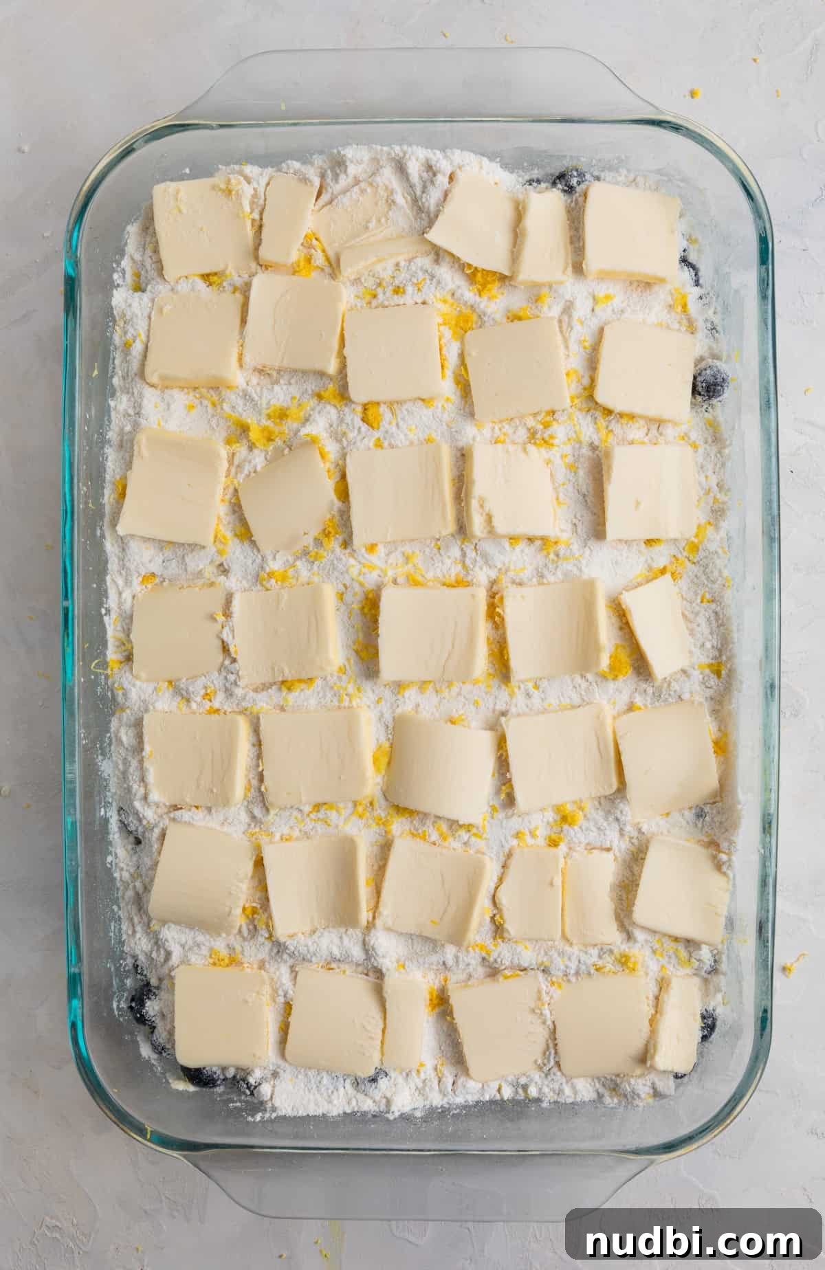 Lemon Blueberry Dump Cake Recipe for Quick Summer Desserts 7 Butter sliced and lined edge to edge of baking pan over cake mix.