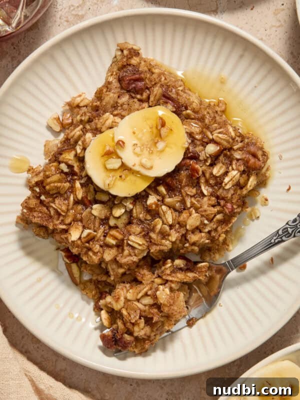 Banana Bread Granola Recipe — Crunchy Banana Oat Clusters 12 Banana bread baked oatmeal on plate with sliced bananas on top.