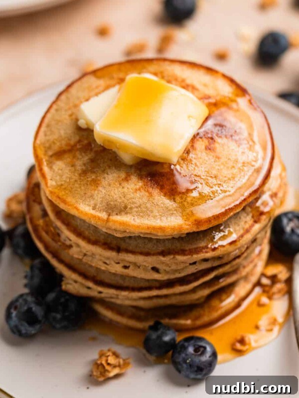 Banana Bread Granola Recipe — Crunchy Banana Oat Clusters 15 Stack of hot cakes made with bananas and oats topped with butter and maple syrup.