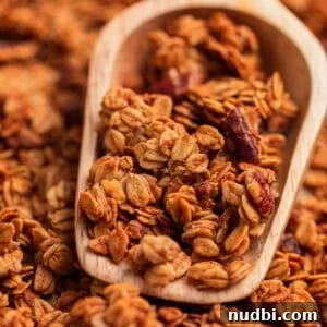 Banana Bread Granola Recipe — Crunchy Banana Oat Clusters 16 Scooper with banana granola in it.
