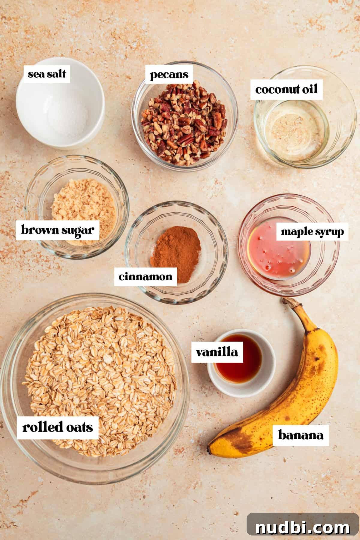 Banana Bread Granola Recipe — Crunchy Banana Oat Clusters 4 Old fashioned oats, coconut oil, pecans and other ingredients on surface.