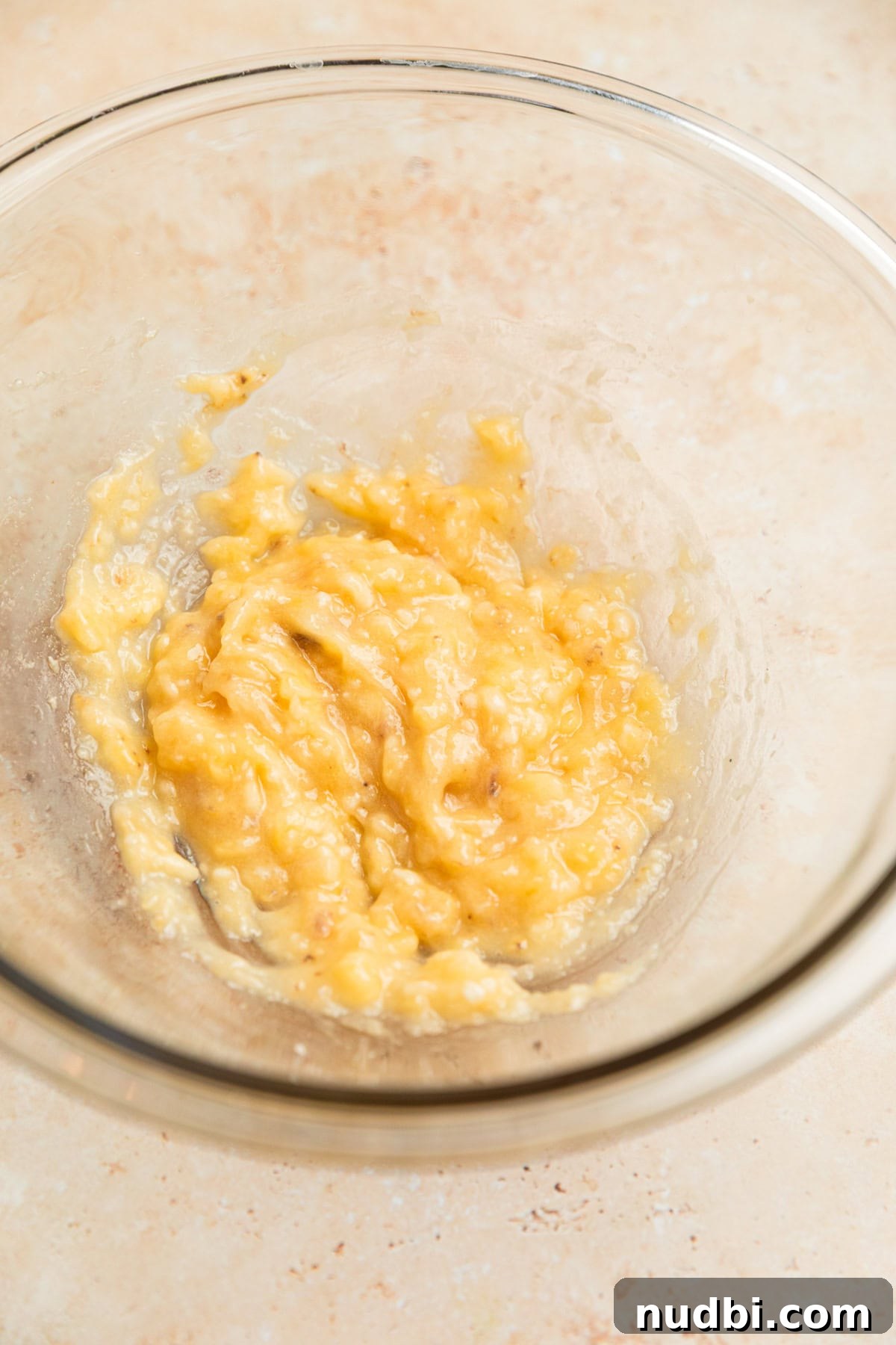 Banana Bread Granola Recipe — Crunchy Banana Oat Clusters 5 Banana mashed in glass bowl.