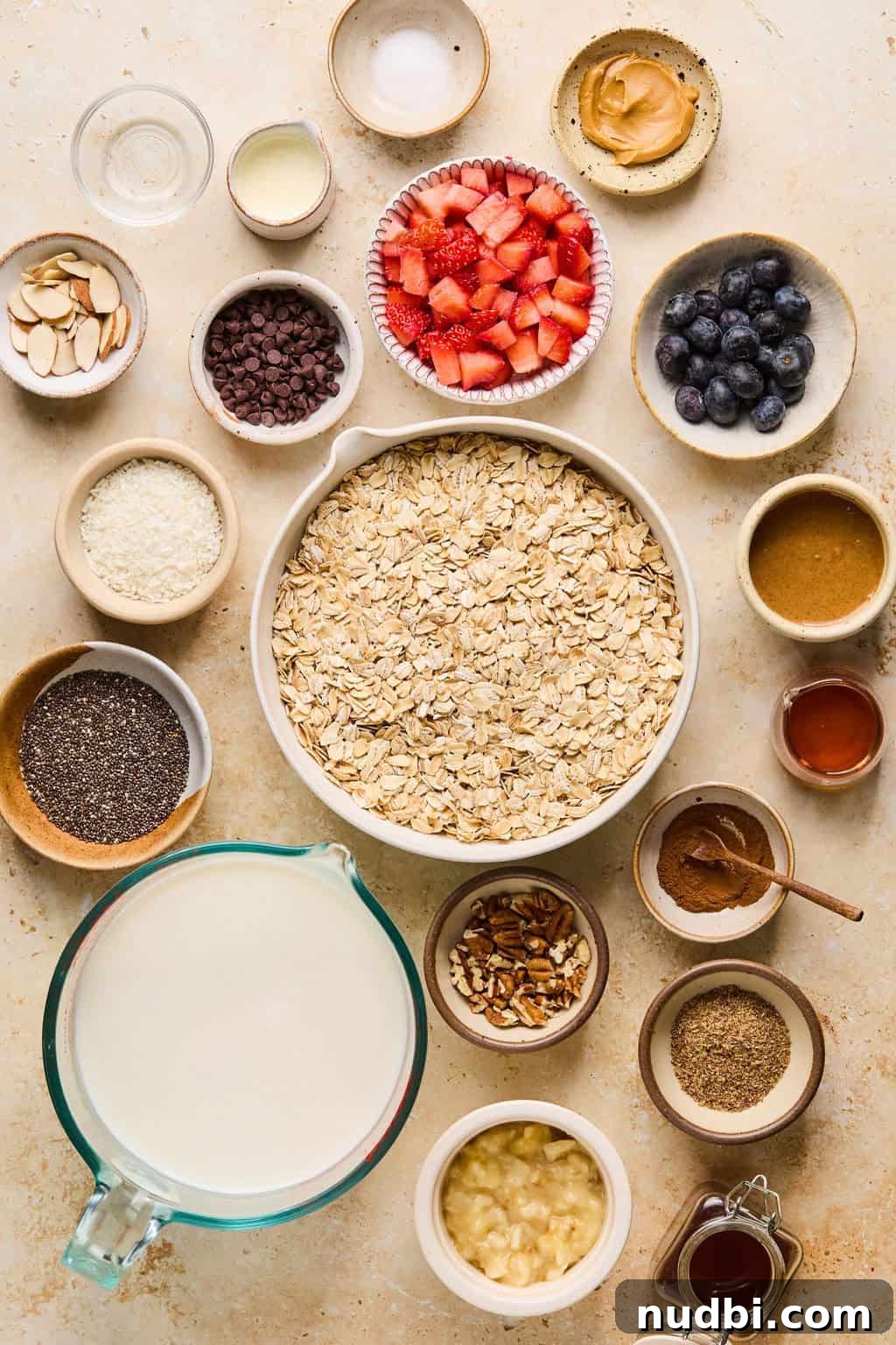 6 Overnight Oats Recipes for Quick, Nutritious Breakfasts 4 Rolled oats, milk, maple syrup, chia seeds, berries and other ingredients arranged on a surface.