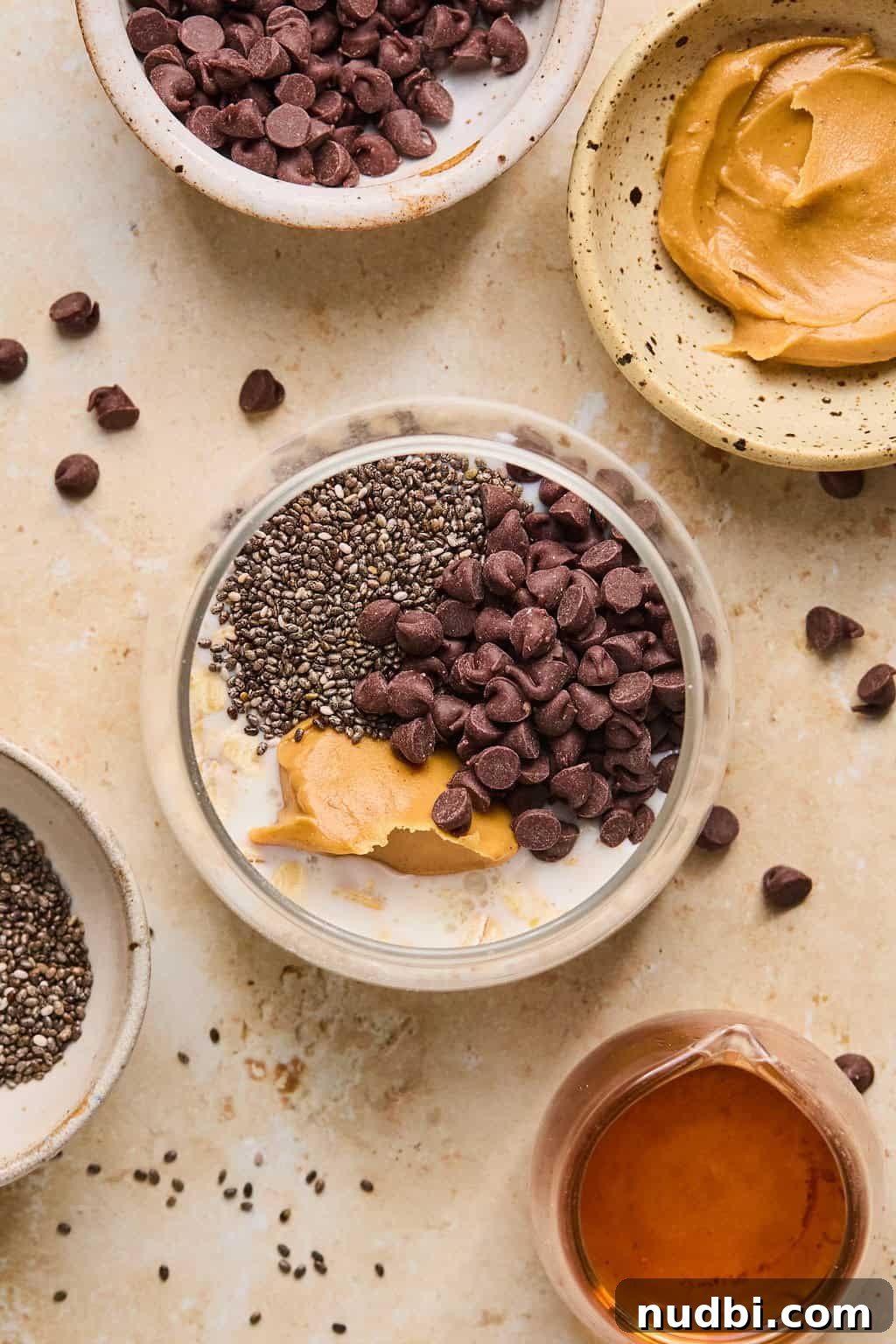 6 Overnight Oats Recipes for Quick, Nutritious Breakfasts 5 Ingredients for peanut butter chocolate oatmeal arranged on surface with them all added to jar before stirring.