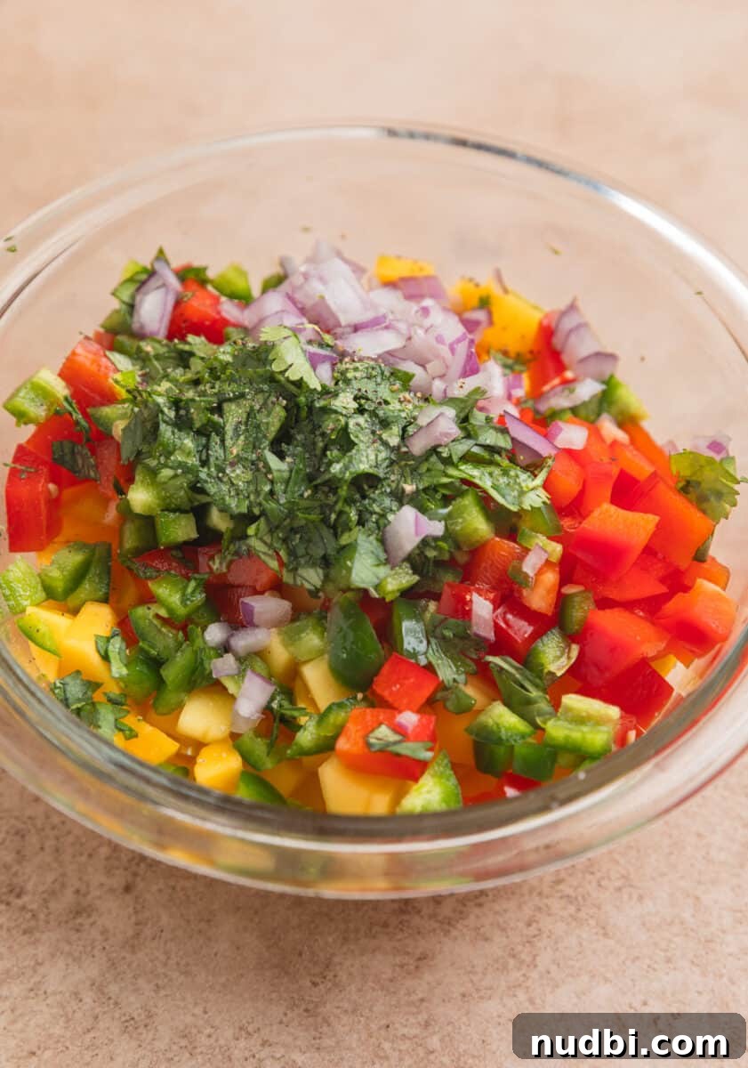 Grilled Chicken with Fresh Mango Salsa Recipe 6 Diced mango, red bell pepper, onion and other salsa ingredients in mixing bowl.
