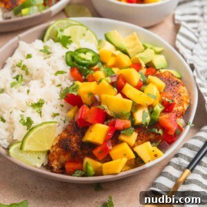 Grilled Chicken with Fresh Mango Salsa Recipe 10 Mango salsa chicken served on plate with white rice and lime.