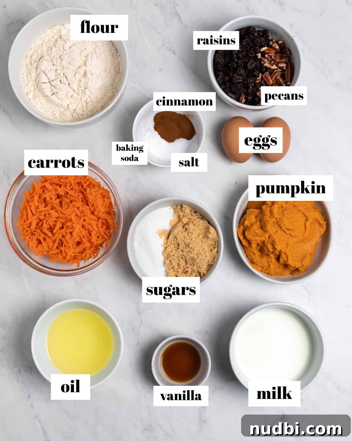 Moist Pumpkin and Carrot Muffins with Warm Spices 4 Ingredients to make muffin recipe labeled on counter.