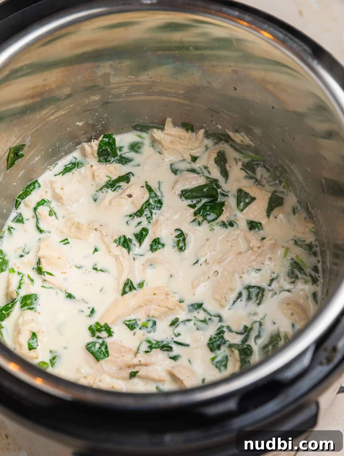 Creamy Parmesan Chicken in the Instant Pot: Tender 30-Minute Recipe 6 Creamy chicken in Instant pot with parmesan and spinach.