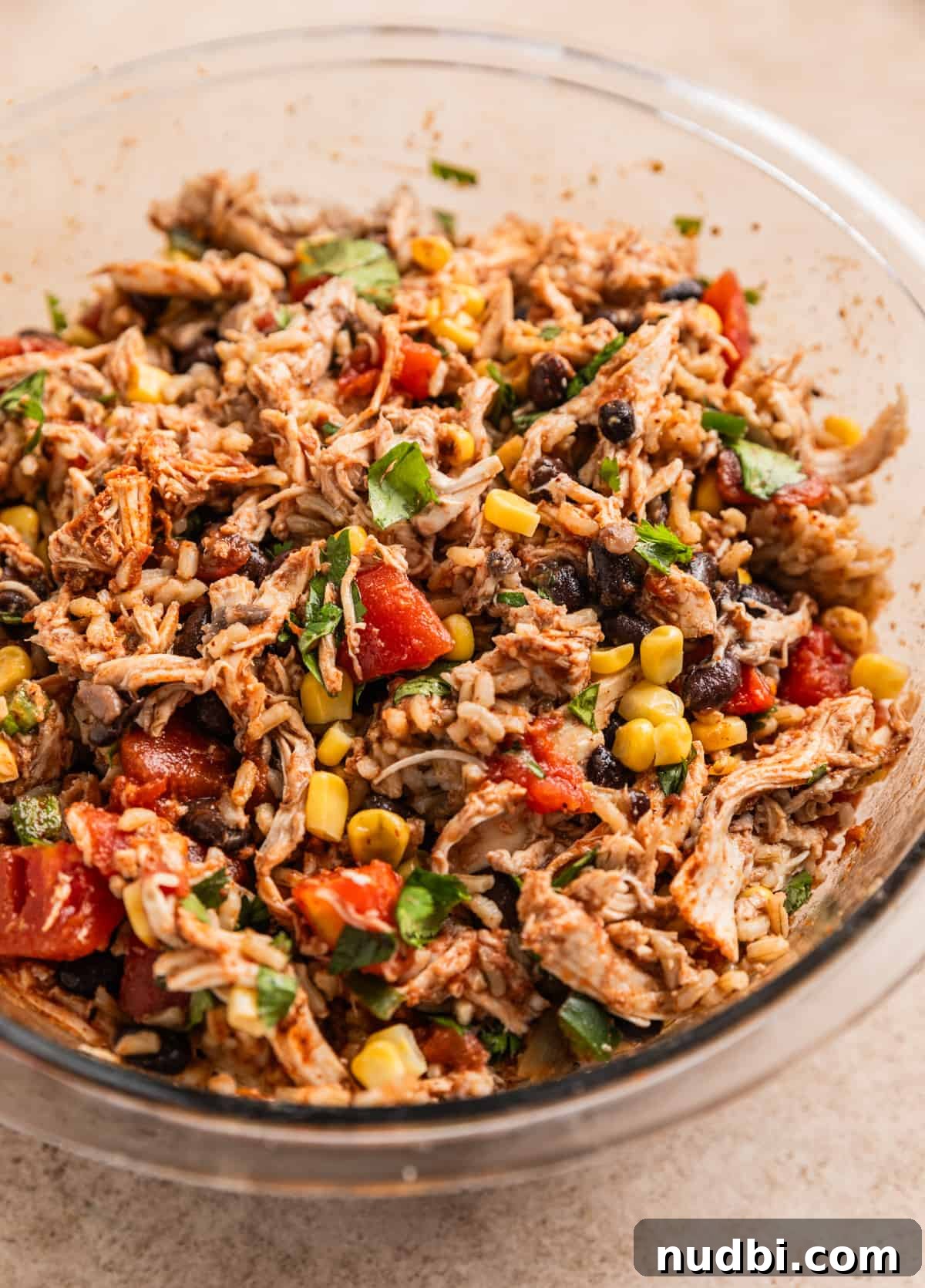 Chicken-Stuffed Poblano Peppers with Savory Cheese Filling 4 Chicken, rice, tomatoes, corn and beans mixed together in glass mixing bowl.