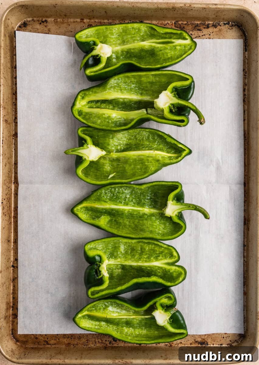 Chicken-Stuffed Poblano Peppers with Savory Cheese Filling 5 Poblano peppers halved on parchment lined baking sheet.