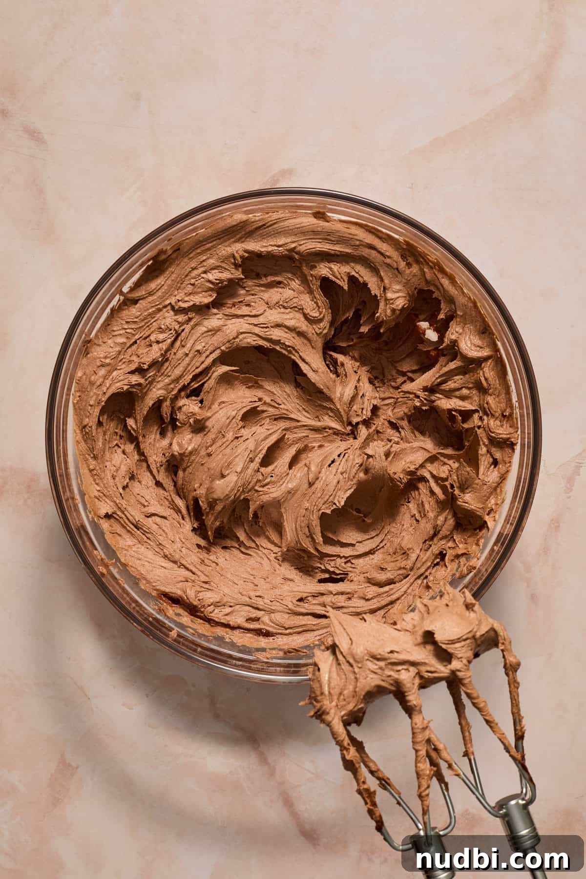 Perfect Cupcake Recipes Using Cake Mix for Fluffy Results 12 Chocolate buttercream prepped in bowl with electric mixer.