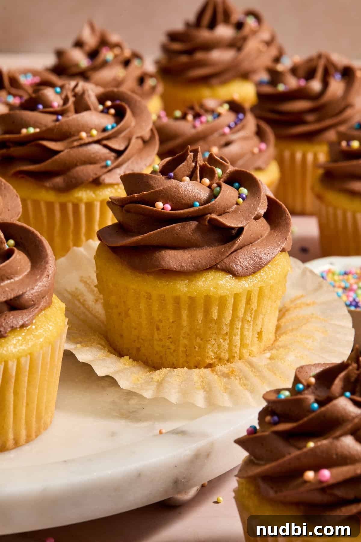 Perfect Cupcake Recipes Using Cake Mix for Fluffy Results 13 Wrapper pulled down off of box cake mix cupcakes to show texture.