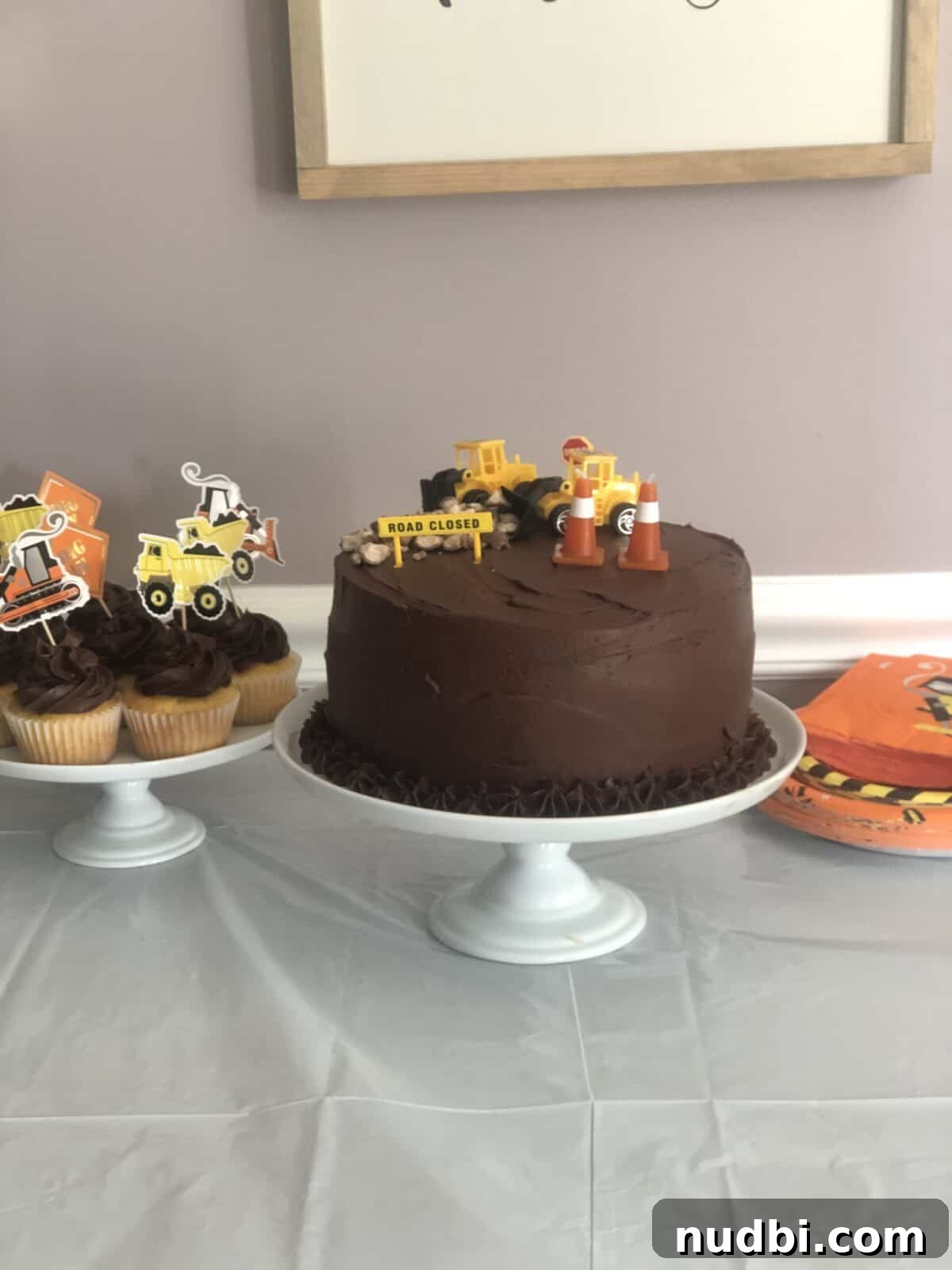 Perfect Cupcake Recipes Using Cake Mix for Fluffy Results 15 Chocolate frosted cake on table with cupcakes.