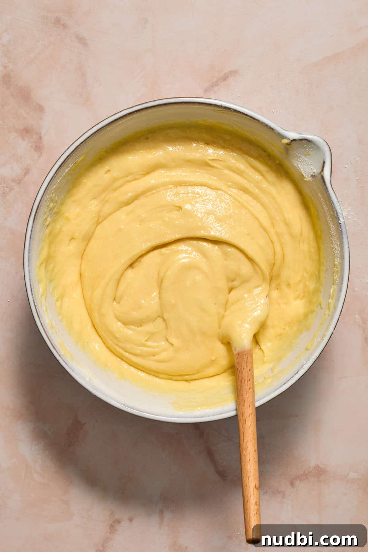 Perfect Cupcake Recipes Using Cake Mix for Fluffy Results 8 Boxed cake mix batter with extra add-ins and spatula propped in bowl.