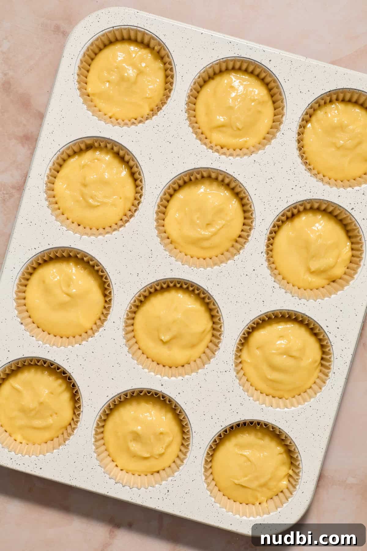 Perfect Cupcake Recipes Using Cake Mix for Fluffy Results 9 Vanilla cupcake batter in muffin tin before baking.