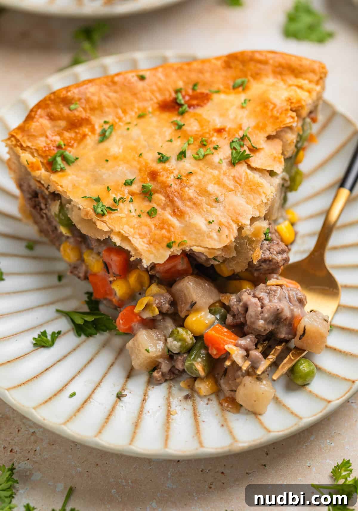 Savory Ground Beef Pot Pie Recipe with Flaky Crust 2 Ground beef pot pie slice on plate with fork.