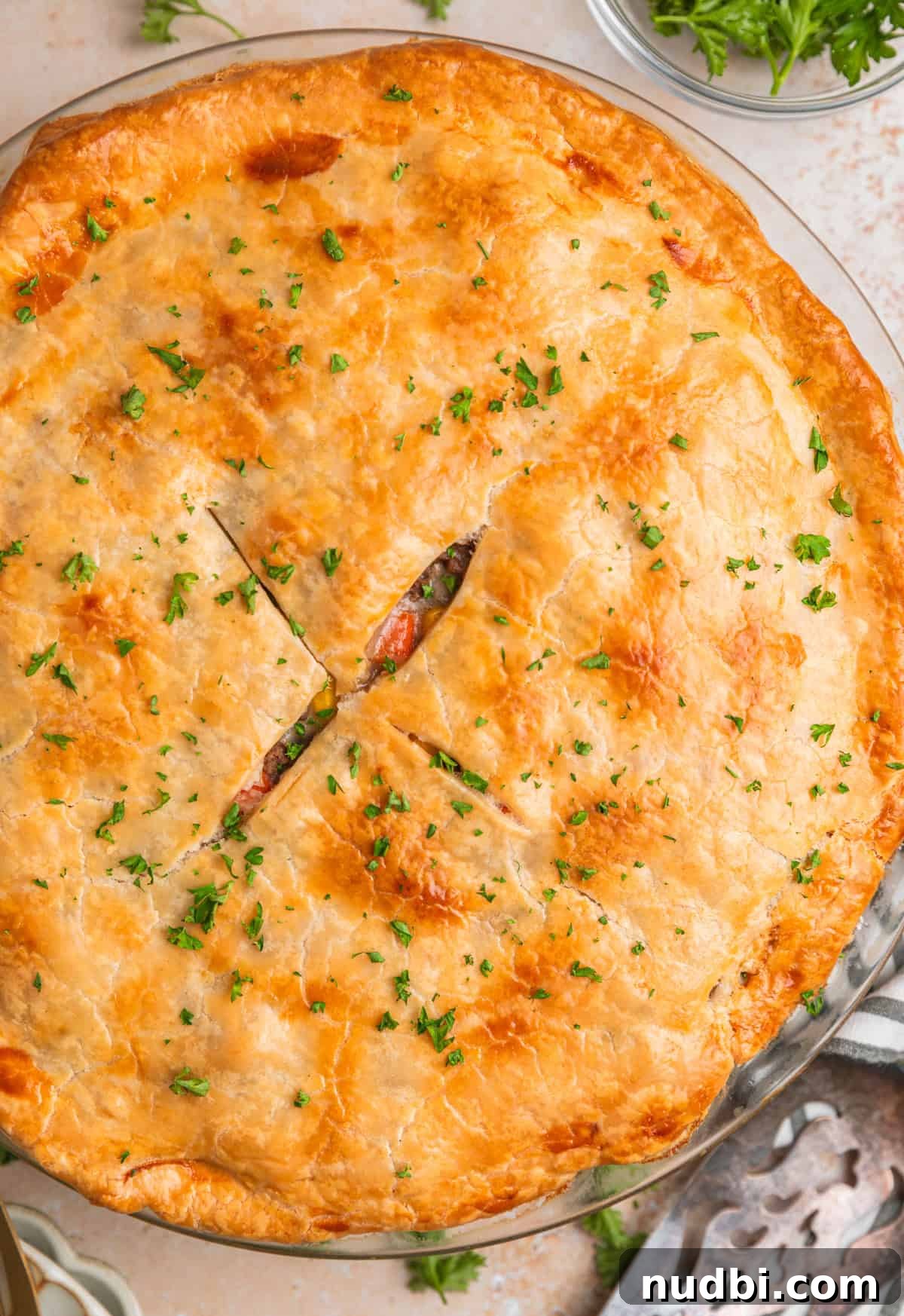 Savory Ground Beef Pot Pie Recipe with Flaky Crust 12 Close up view of ground beef pot pie topped with chopped parsley.