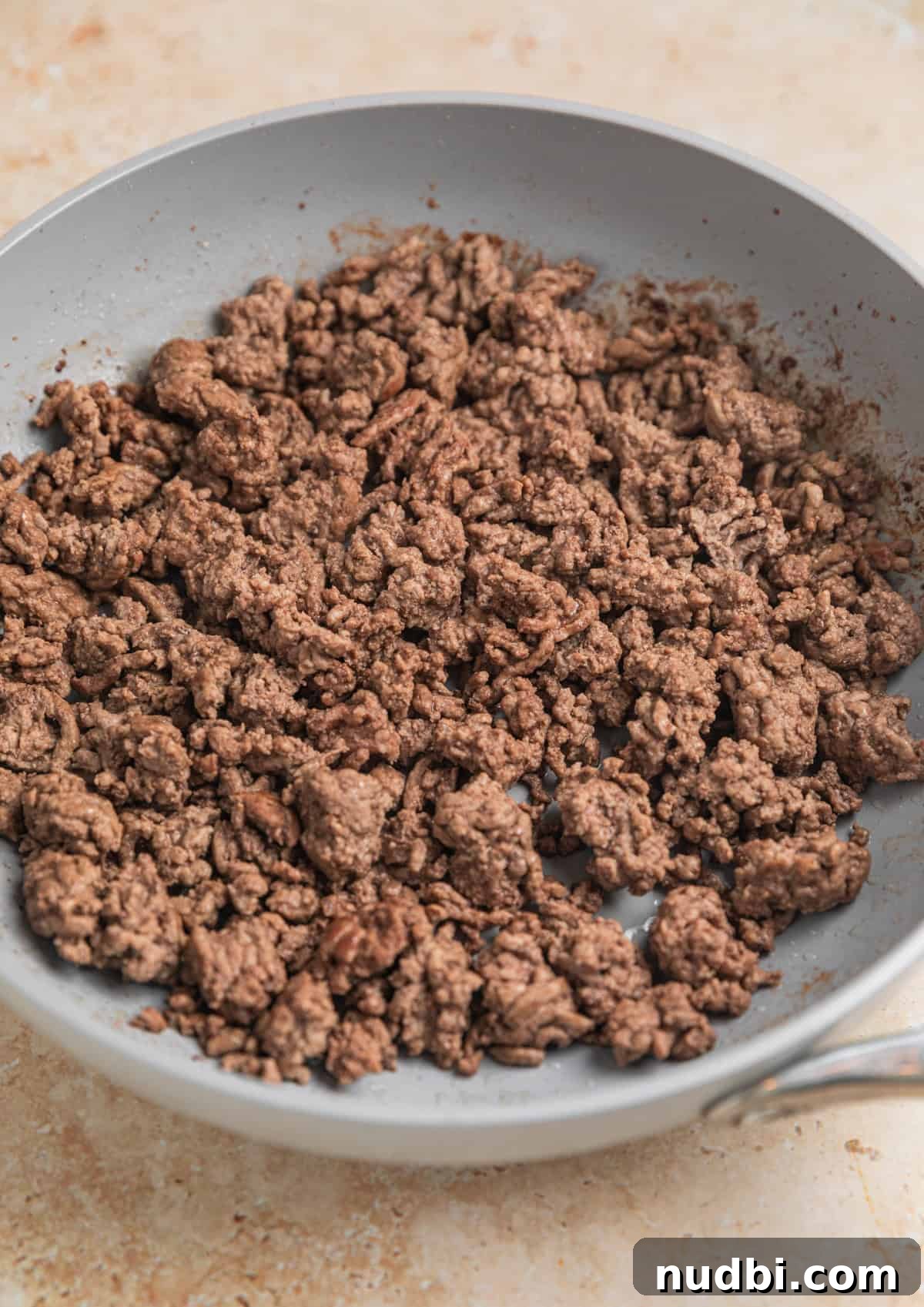 Savory Ground Beef Pot Pie Recipe with Flaky Crust 3 Browned ground beef in skillet.