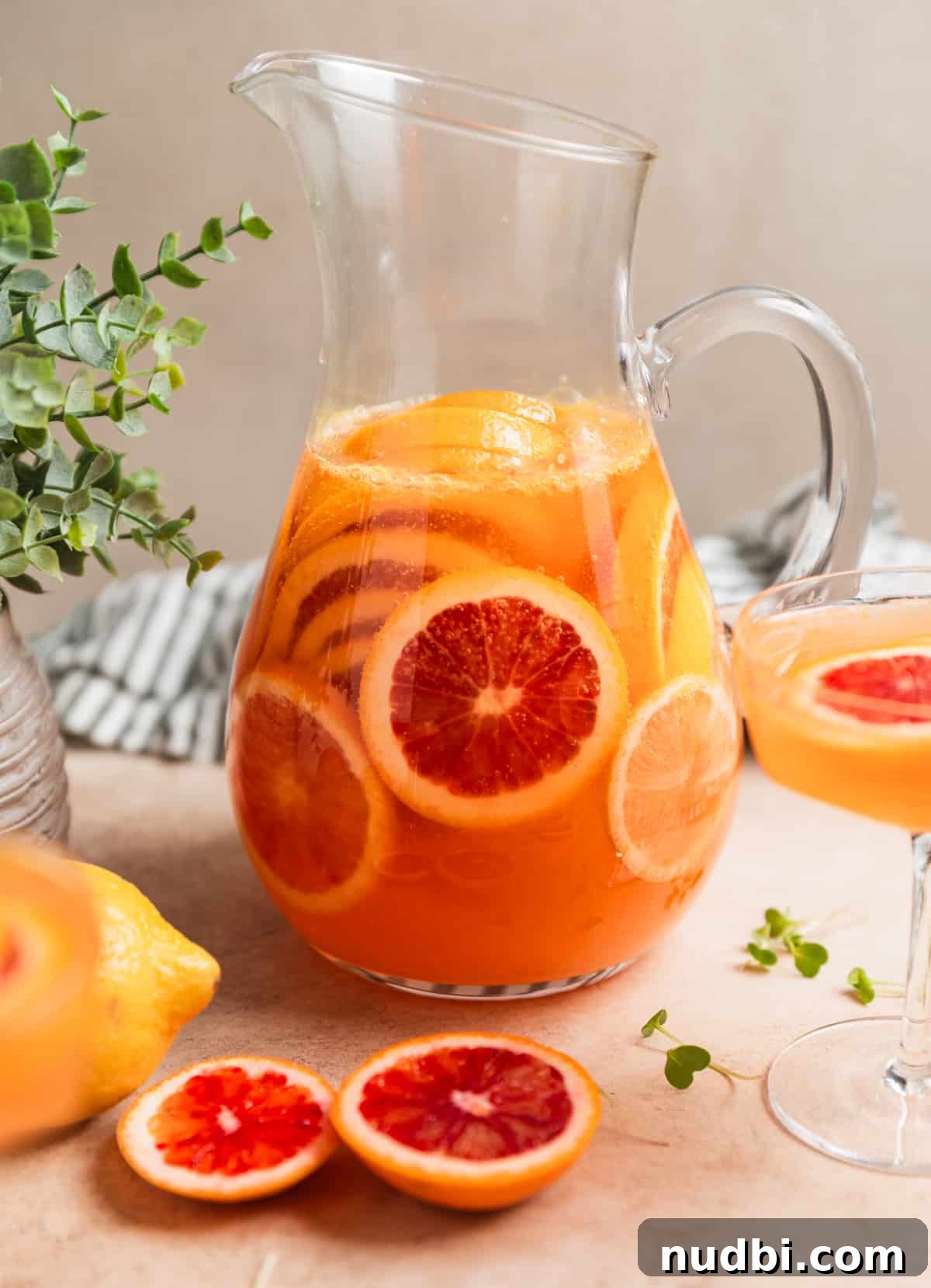 Blood Orange Champagne Sangria Recipe for Sparkling Brunch Drinks 3 Pitcher of champagne sangria with blood oranges in it.