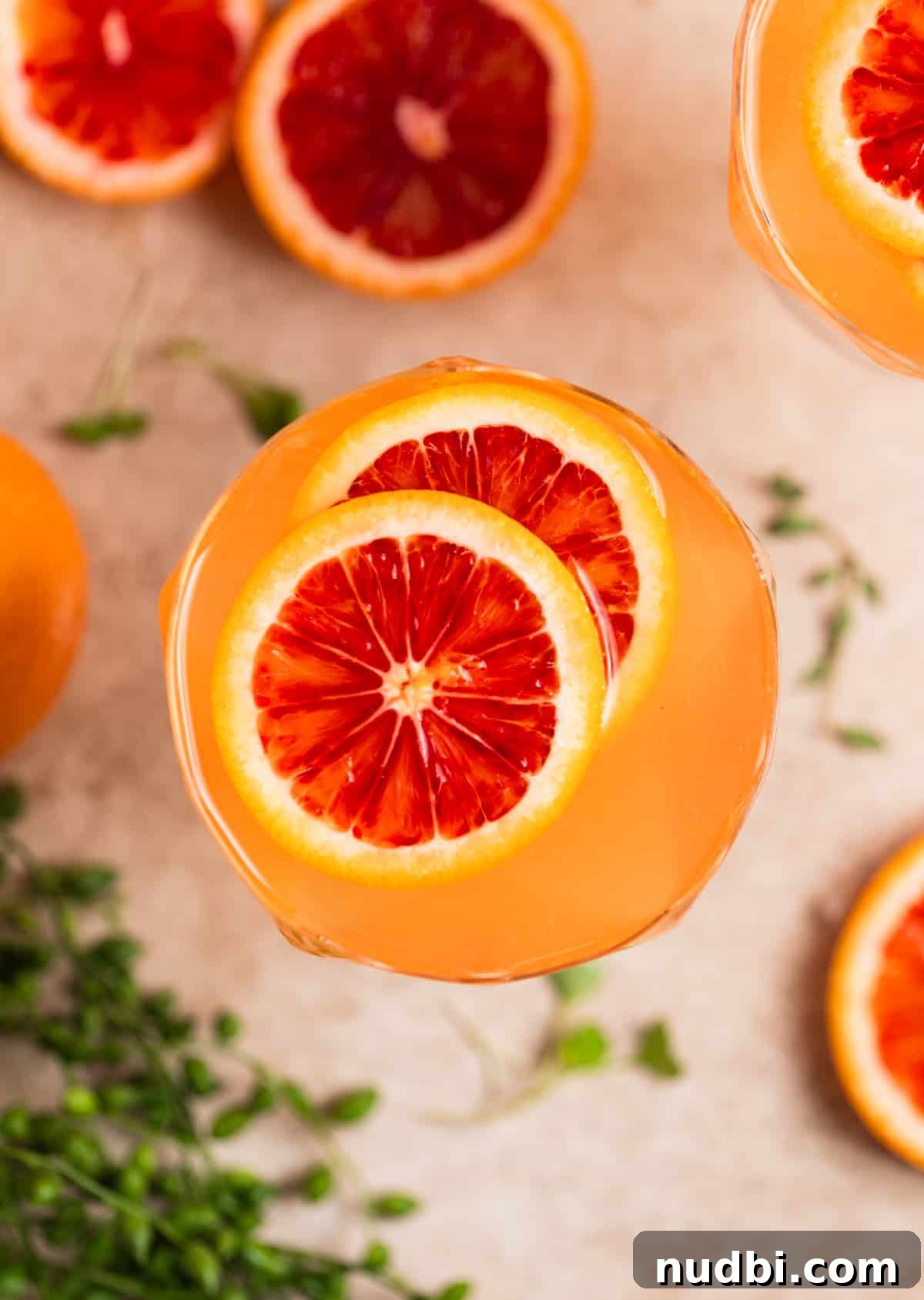 Blood Orange Champagne Sangria Recipe for Sparkling Brunch Drinks 4 Overhead view of champagne cocktail with blood orange garnish.