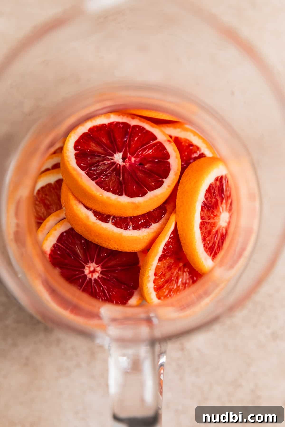 Blood Orange Champagne Sangria Recipe for Sparkling Brunch Drinks 6 Blood oranges in pitcher, sliced.