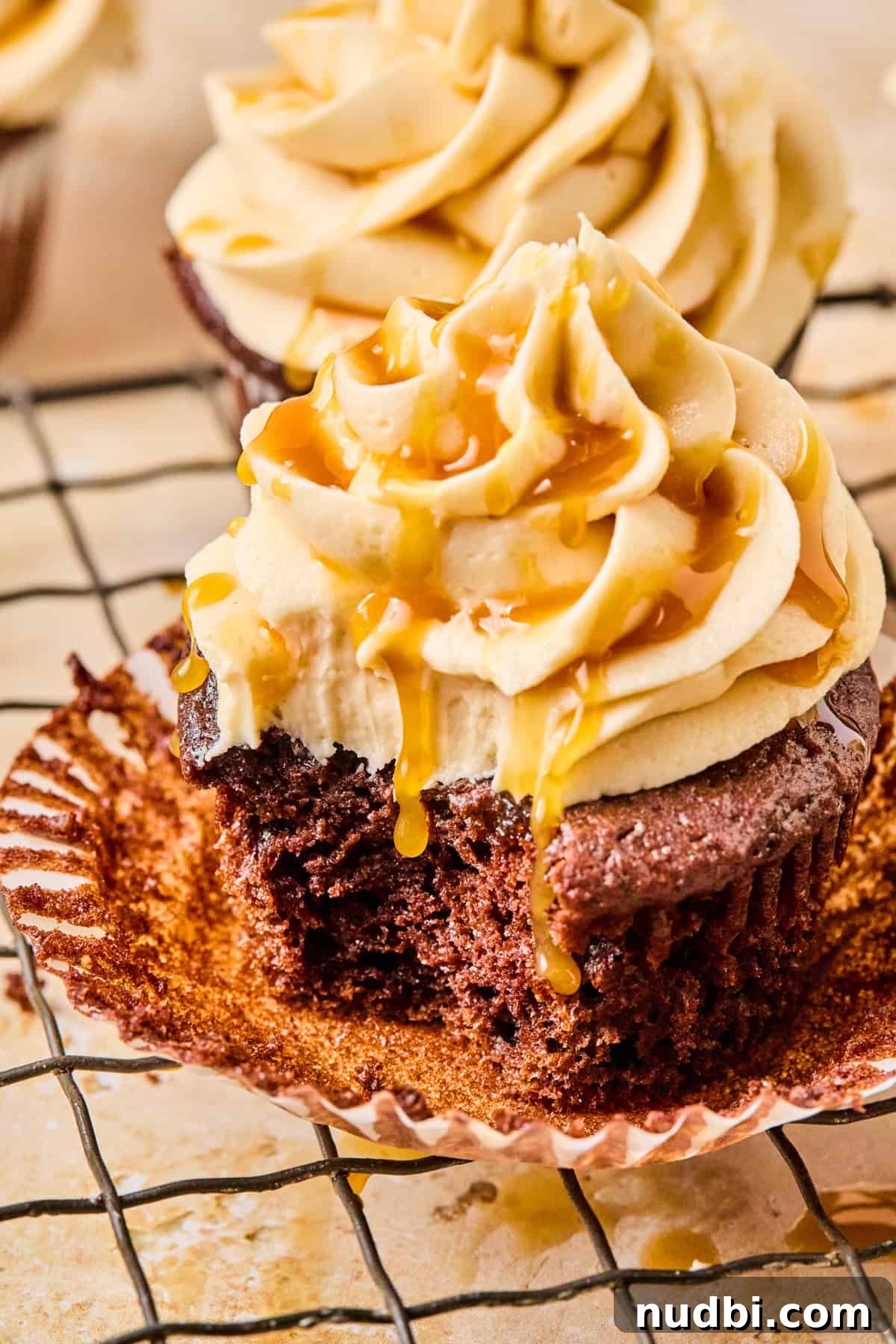 Salted Caramel Mocha Cupcakes Recipe for Coffee Lovers 4 Cafe mocha cupcake with caramel frosting with bite taken out.