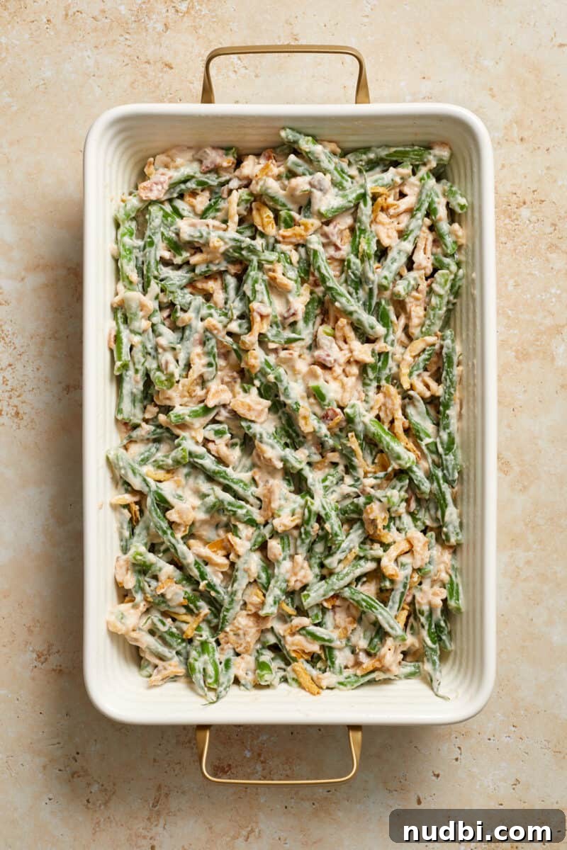 Cheesy Bacon Green Bean Casserole Recipe with Crispy Topping 7 Bacon and green bean casserole mixture before baking in casserole dish.
