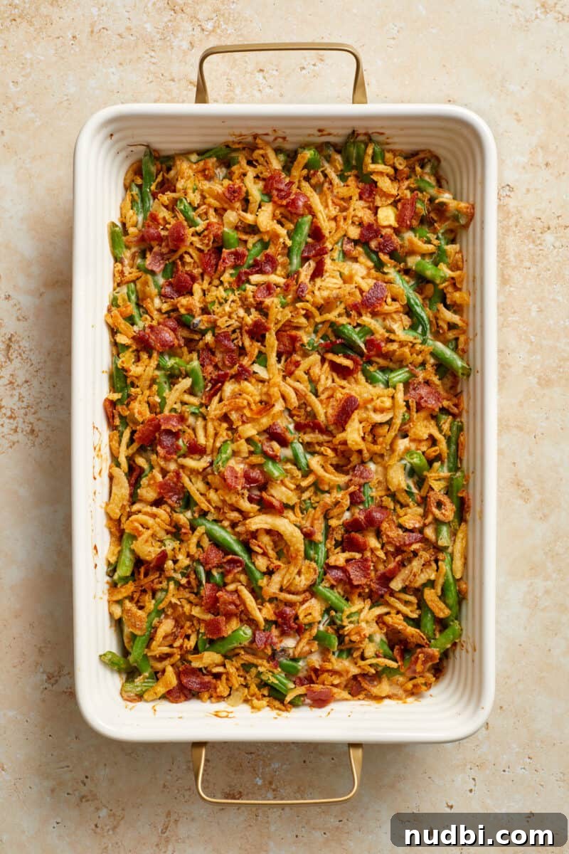 Cheesy Bacon Green Bean Casserole Recipe with Crispy Topping 8 Baked green bean casserole topped with fried onions and bacon.
