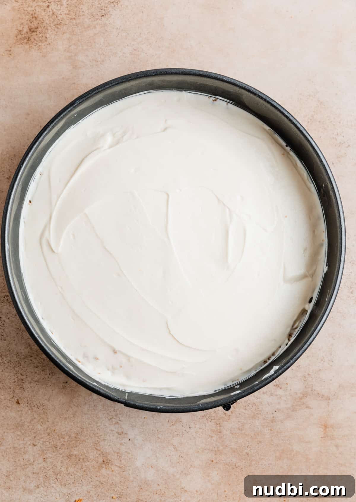 No-Bake Caramel Apple Cheesecake Recipe for Fall Gatherings 14 No bake cheesecake in springform pie pan before chilling.