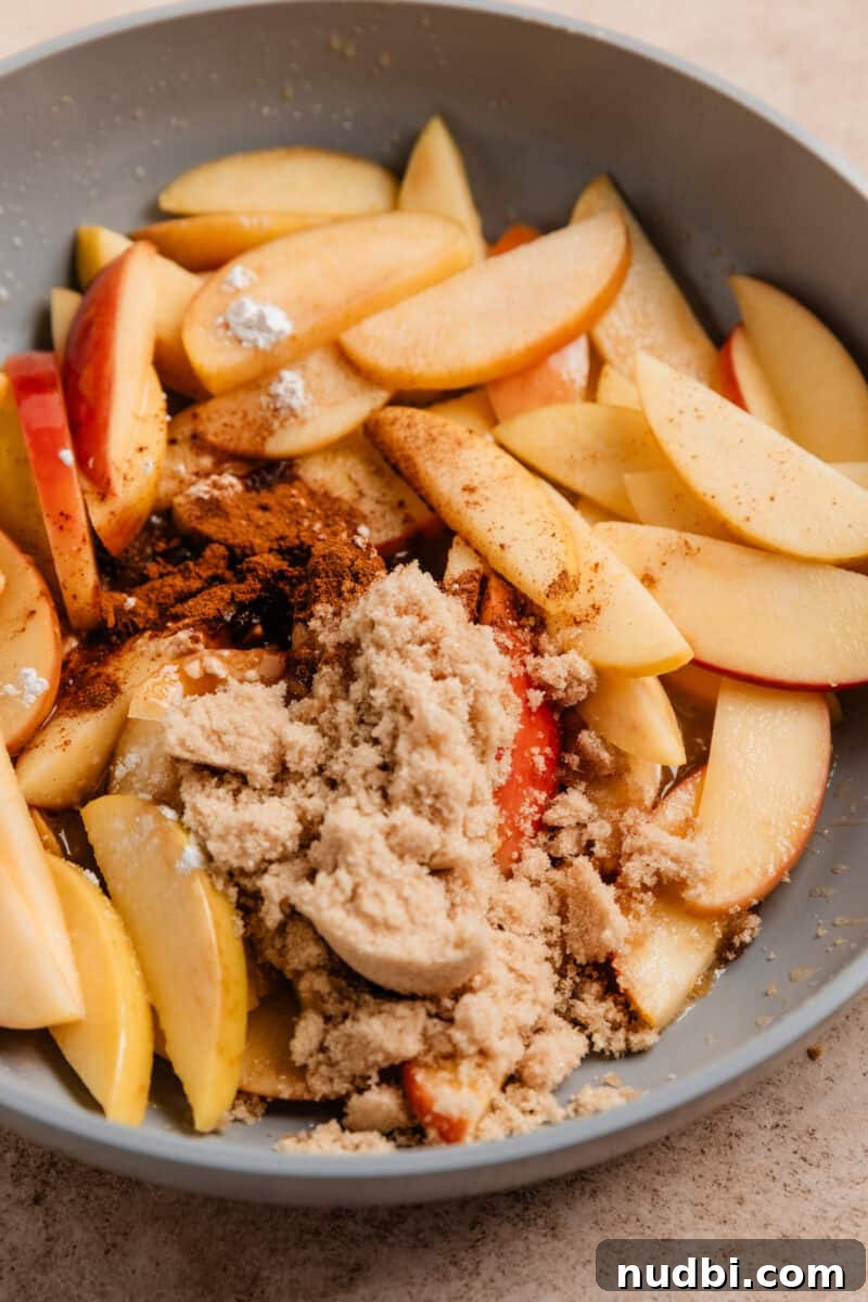 No-Bake Caramel Apple Cheesecake Recipe for Fall Gatherings 15 Brown sugar, cinnamon and corn starch added to skillet with fried apples.