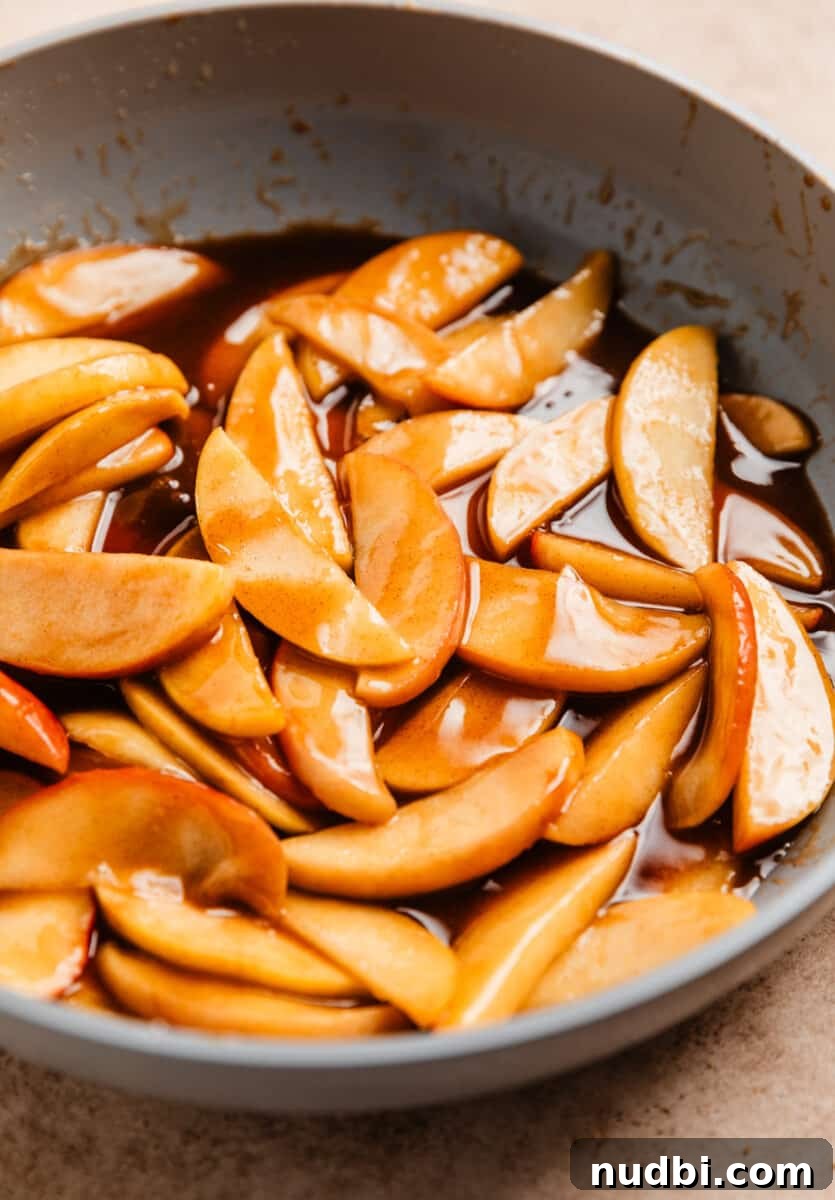 No-Bake Caramel Apple Cheesecake Recipe for Fall Gatherings 17 Caramel apples fried in skillet.