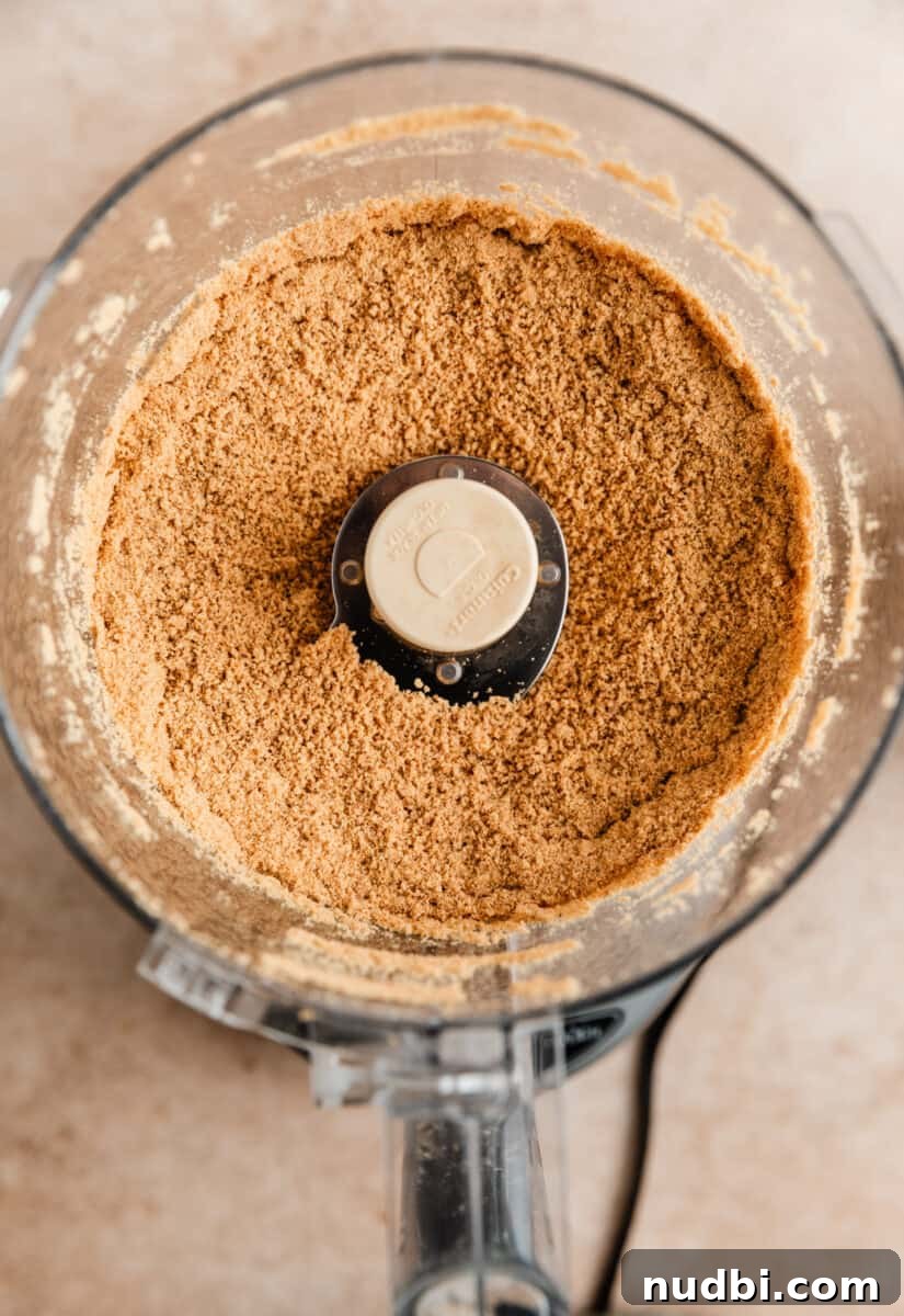 No-Bake Caramel Apple Cheesecake Recipe for Fall Gatherings 5 Ground up graham cracker crumbs in food processor.
