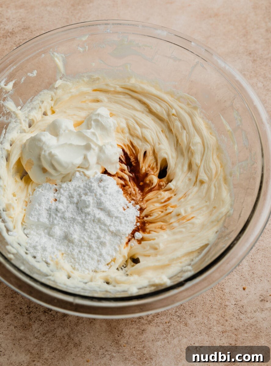 No-Bake Caramel Apple Cheesecake Recipe for Fall Gatherings 9 Vanilla, powdered sugar, and sour cream added to cheesecake mixture.