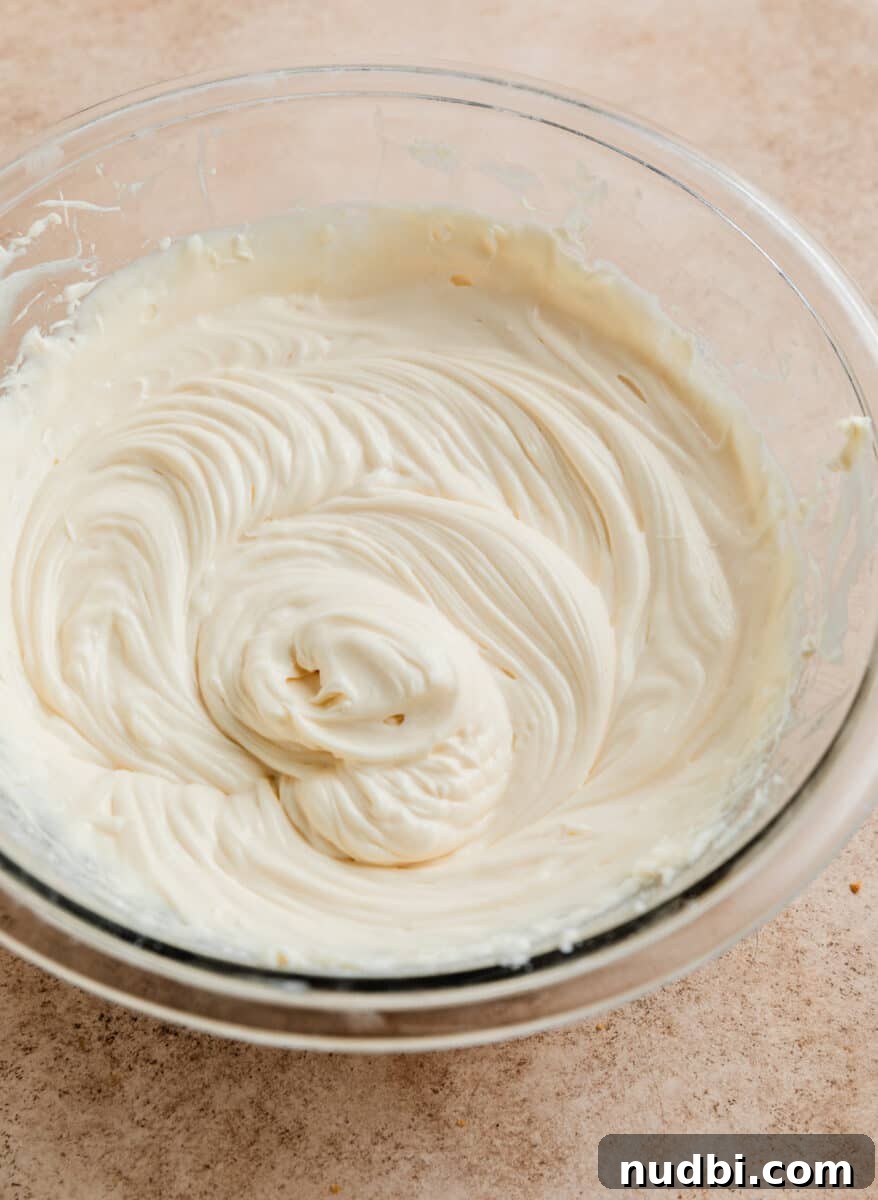 No-Bake Caramel Apple Cheesecake Recipe for Fall Gatherings 10 Cheesecake mixture after sour cream, powdered sugar and vanilla added.