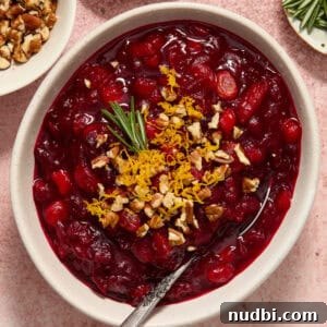 Cranberry Apple Chutney Recipe for Holidays and Leftovers 7 Bowl of apple cranberry chutney with orange zest, pecans and rosemary on top.