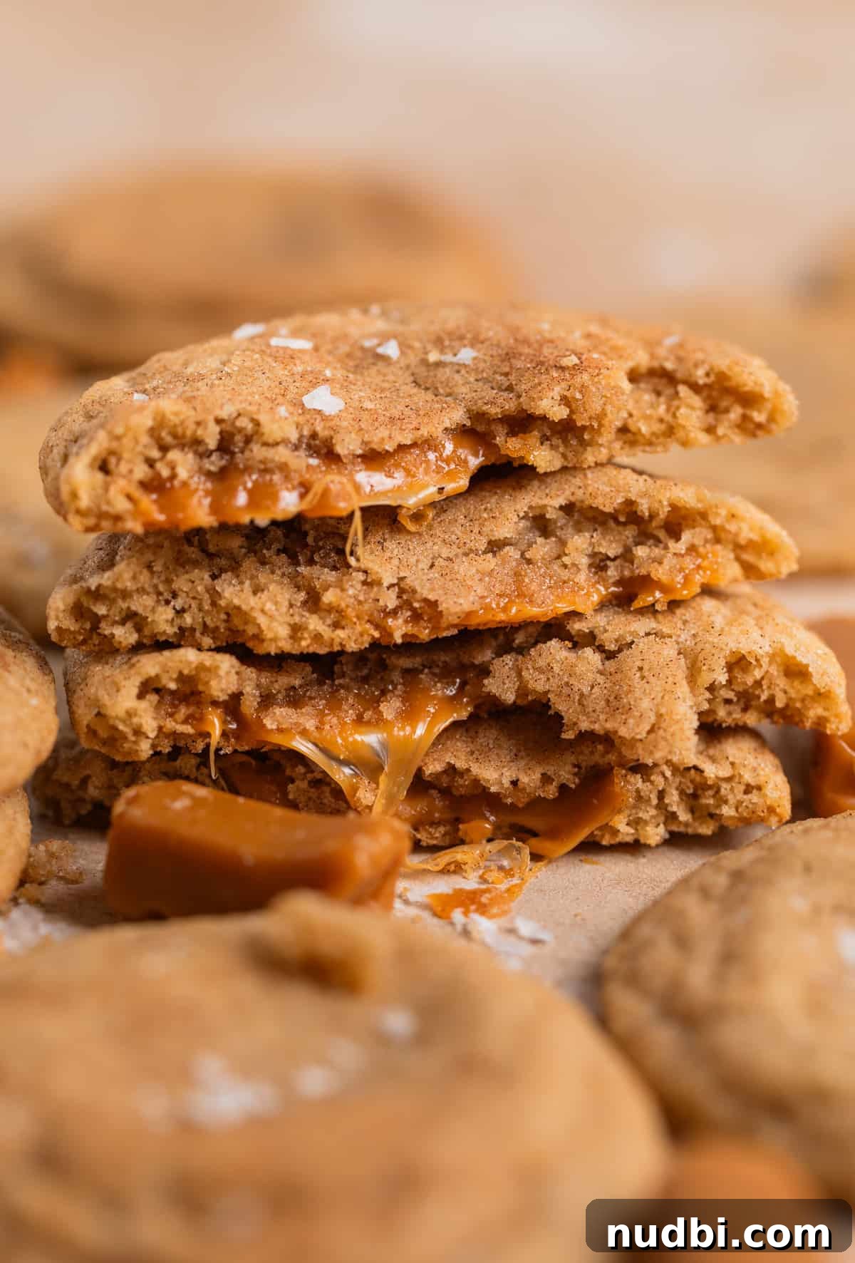 Chewy Snickerdoodle Cookies Filled with Caramel 2 Stack of caramel stuffed snickerdoodle cookies broken in half to show the caramel centers.