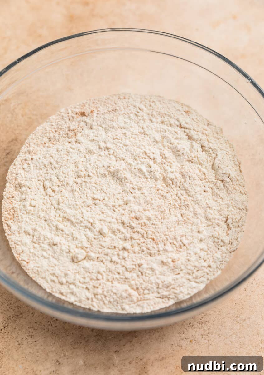 Chewy Snickerdoodle Cookies Filled with Caramel 4 Flour, cinnamon, cream of tartar and salt mixture in glass mixing bowl.