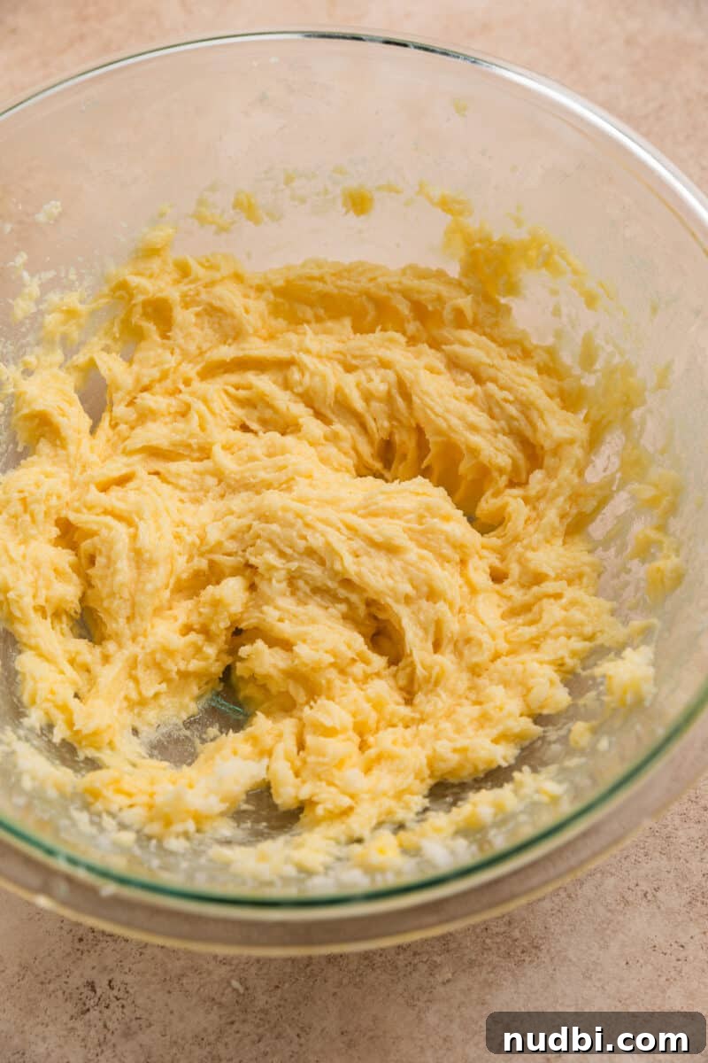 Chewy Snickerdoodle Cookies Filled with Caramel 6 Creamed butter and sugar in mixing bowl with egg and vanilla added in.