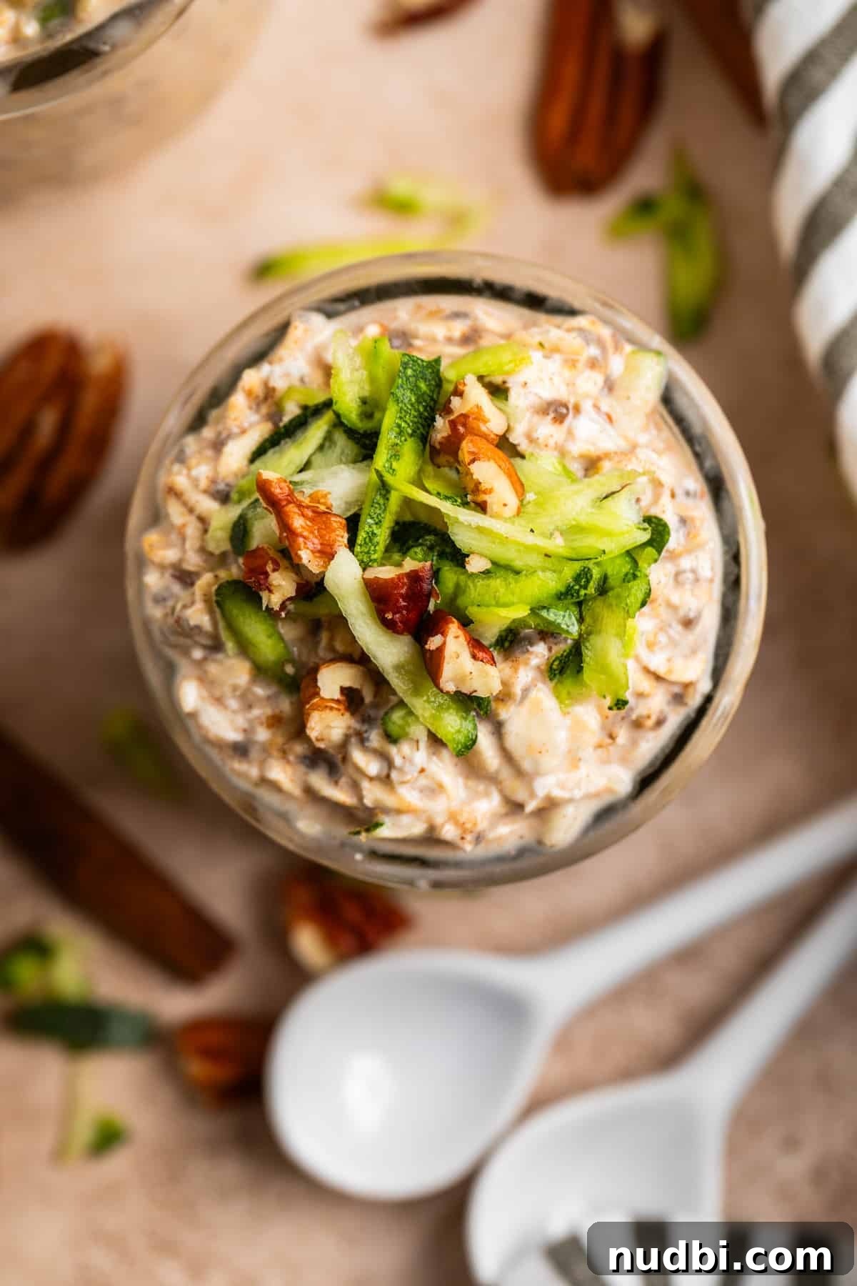 Overnight Zucchini Bread Oats — Moist, Spiced Breakfast Bowl 3 Overhead view of jar with oatmeal topped with zucchini and pecans.