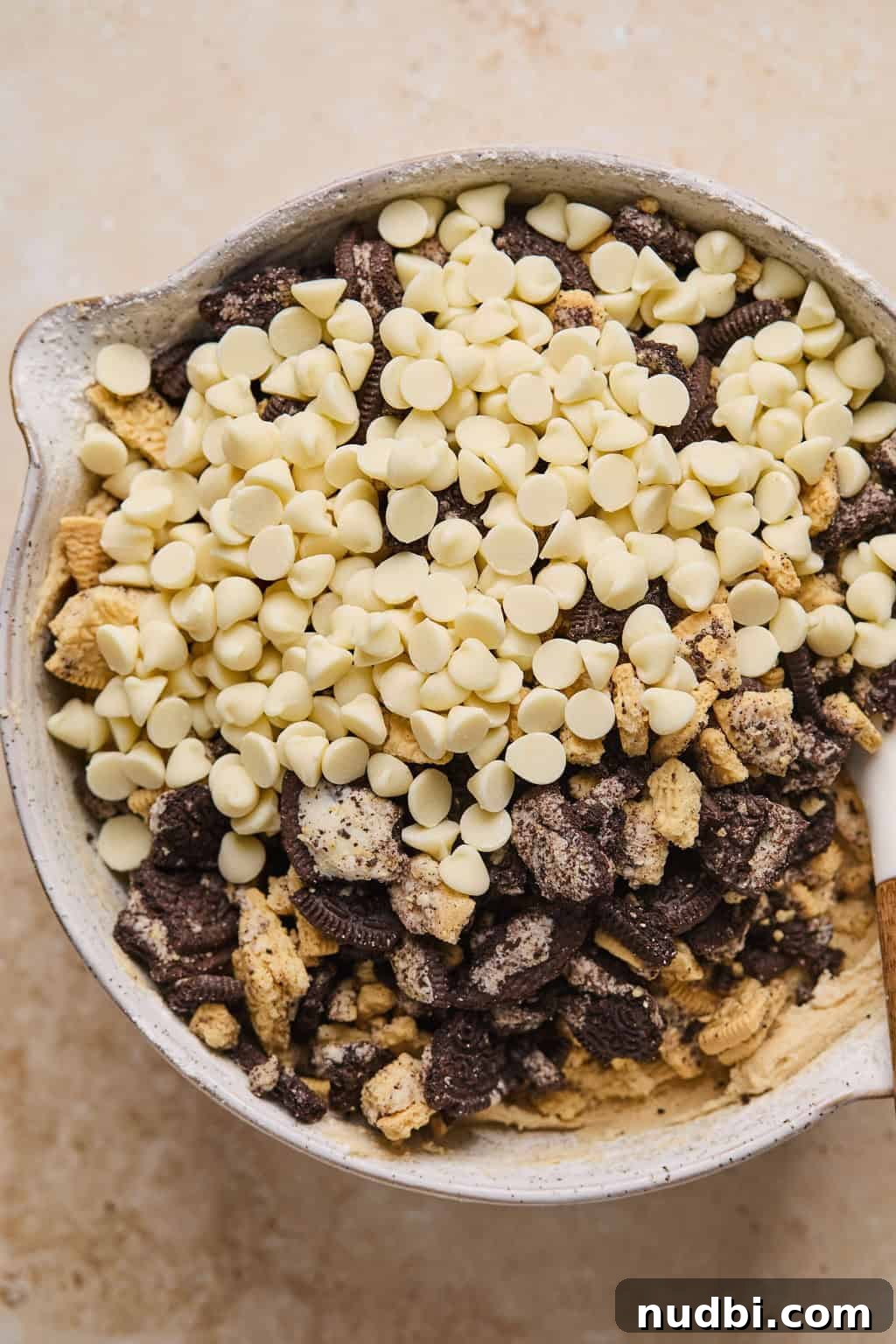 Oreo Chocolate Chip Cookies Recipe — Chewy Oreo-Stuffed Treats 12 Oreos, golden Oreos and white chocolate chips poured over cookie dough mixture.