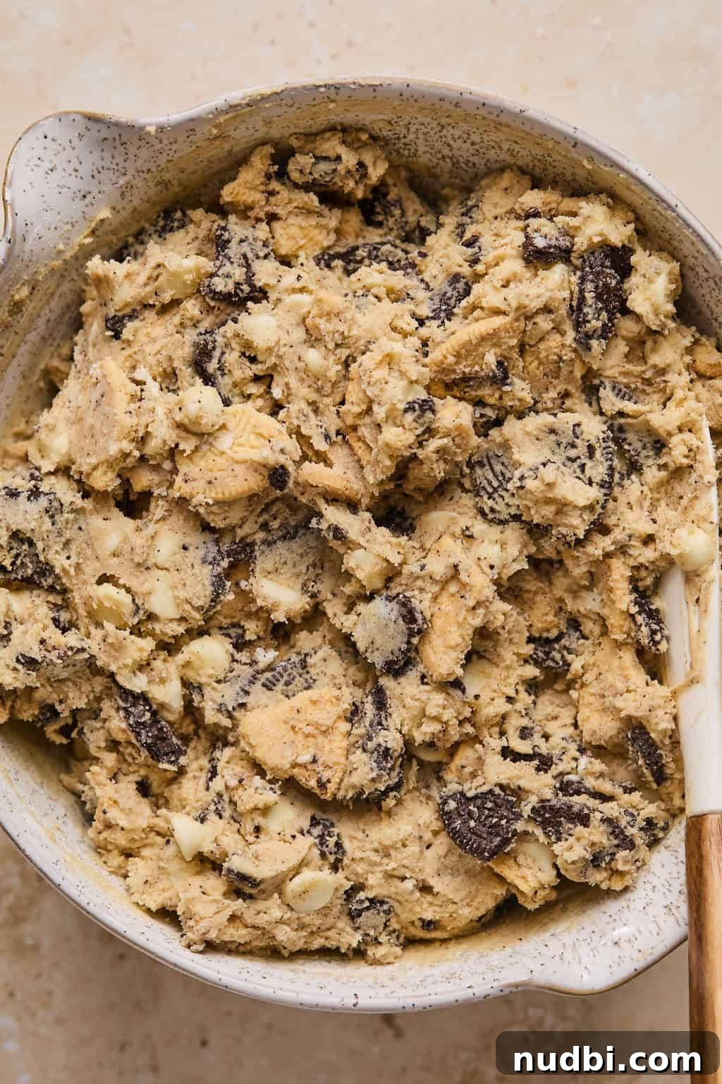 Oreo Chocolate Chip Cookies Recipe — Crispy Edges, Chewy Center 13 Oreo chocolate chip cookie dough in bowl with spoon.