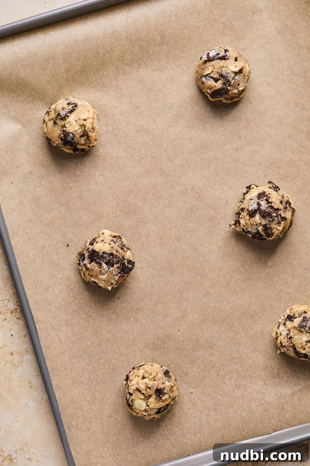 Oreo Chocolate Chip Cookies Recipe — Chewy Oreo-Stuffed Treats 14 Oreo chip cookie dough on parchment lined baking sheet.
