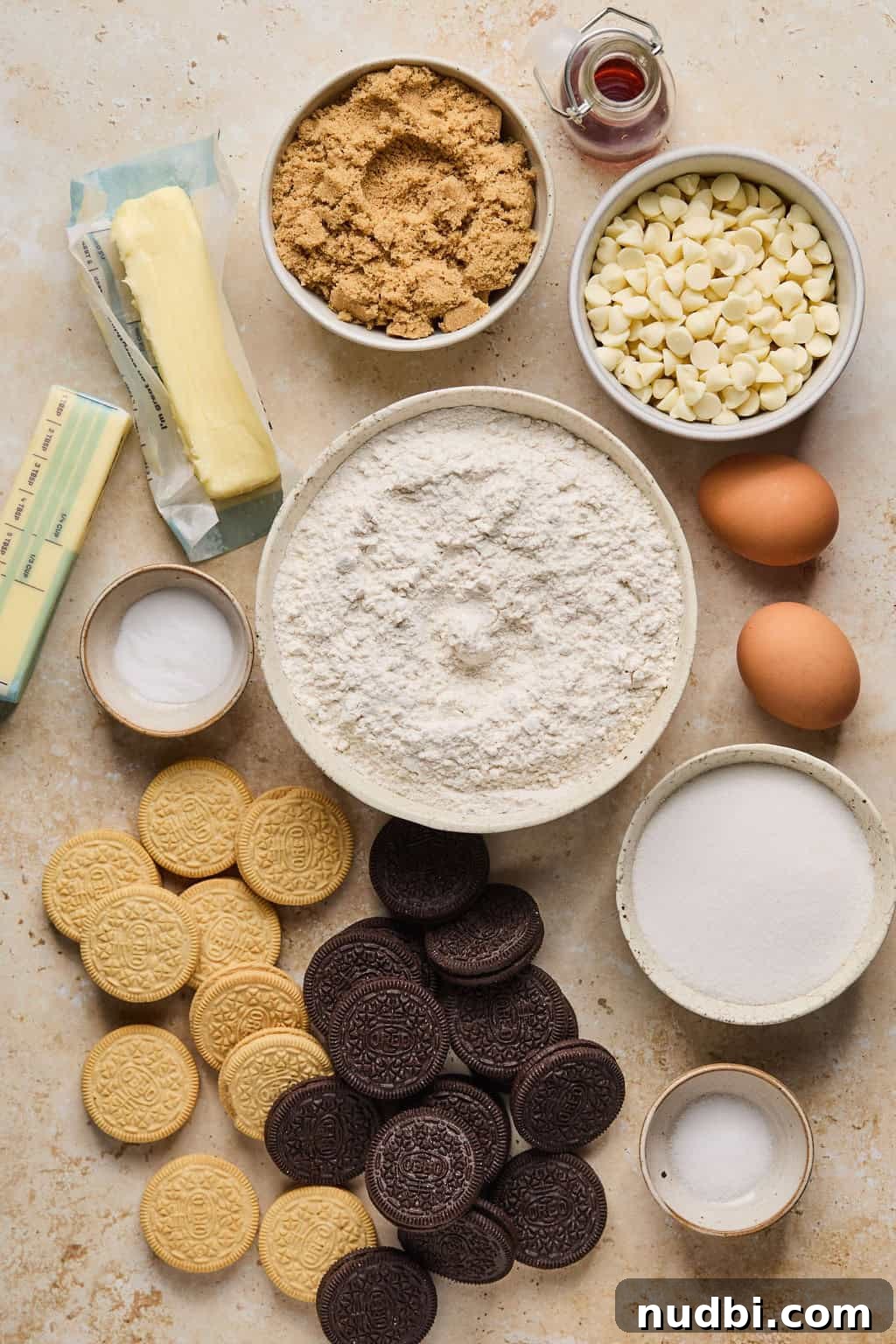 Oreo Chocolate Chip Cookies Recipe — Chewy Oreo-Stuffed Treats 3 Flour, butter, sugars, eggs, white chocolate chips and other ingredients to make cookie recipe on surface.
