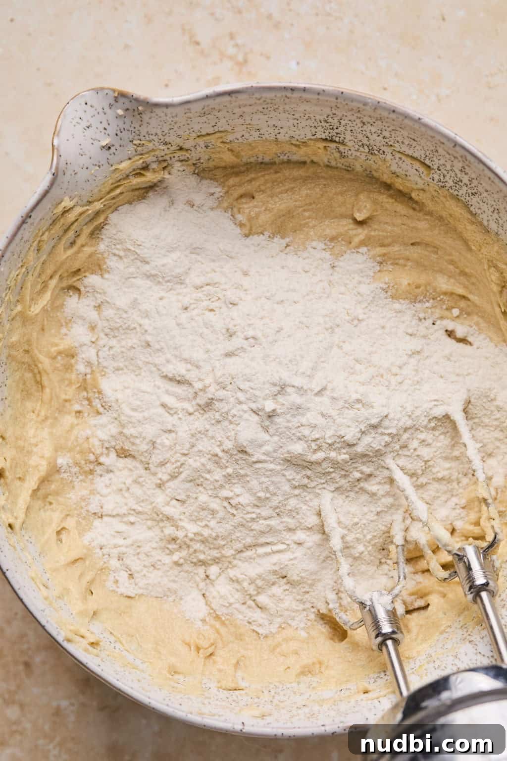 Oreo Chocolate Chip Cookies Recipe — Chewy Oreo-Stuffed Treats 10 Flour mixture poured into wet ingredients in mixing bowl.