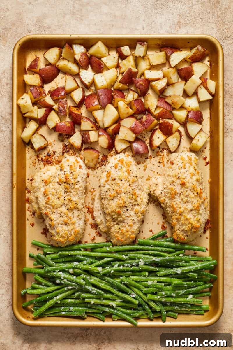 Parmesan-Crusted Chicken Sheet Pan Dinner Recipe 9 Chicken, green beans and potatoes on sheet pan.