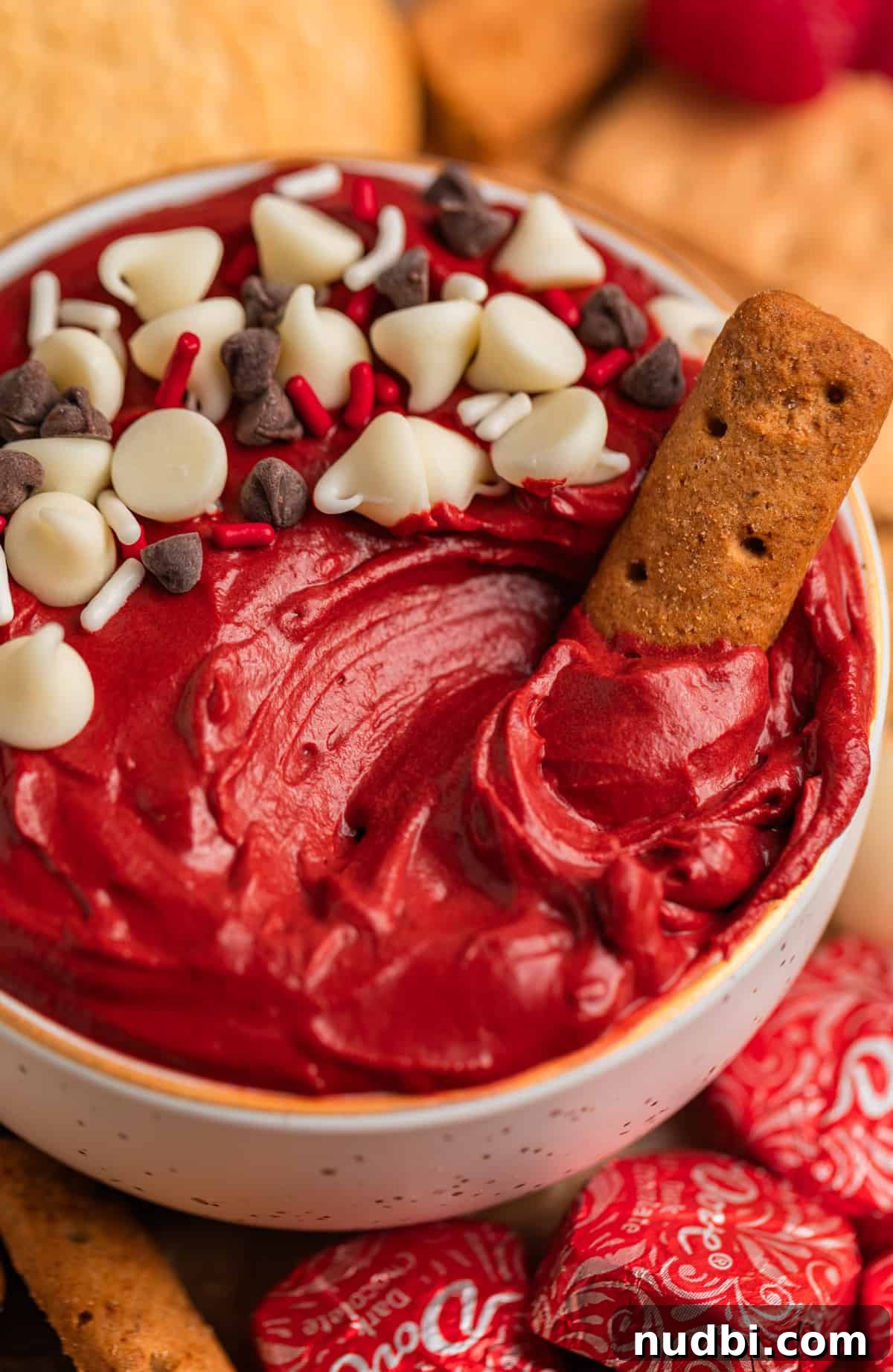 Red Velvet Cheesecake Dip Recipe — Creamy Party Dessert Dip 2 Red velvet dip with white and dark chocolate chips sprinkled on top and graham cracker dipped in.