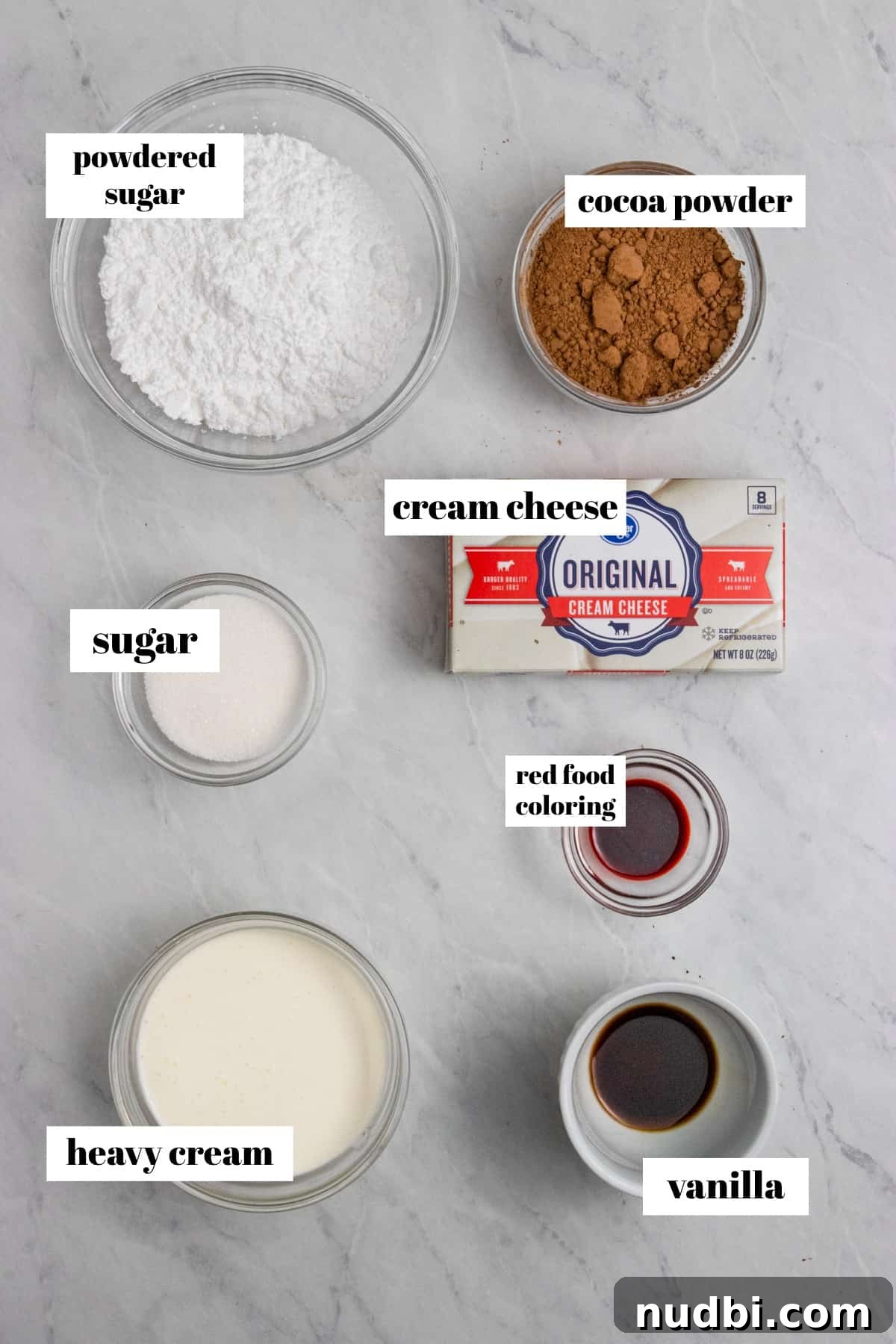 Red Velvet Cheesecake Dip Recipe — Creamy Party Dessert Dip 3 Cream cheese, powdered sugar, cocoa powder and other ingredients labeled on counter.