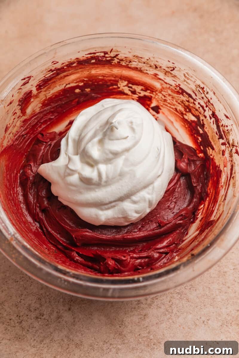 Red Velvet Cheesecake Dip Recipe — Creamy Party Dessert Dip 8 Whipped cream on top of red velvet cheesecake dip in glass bowl.