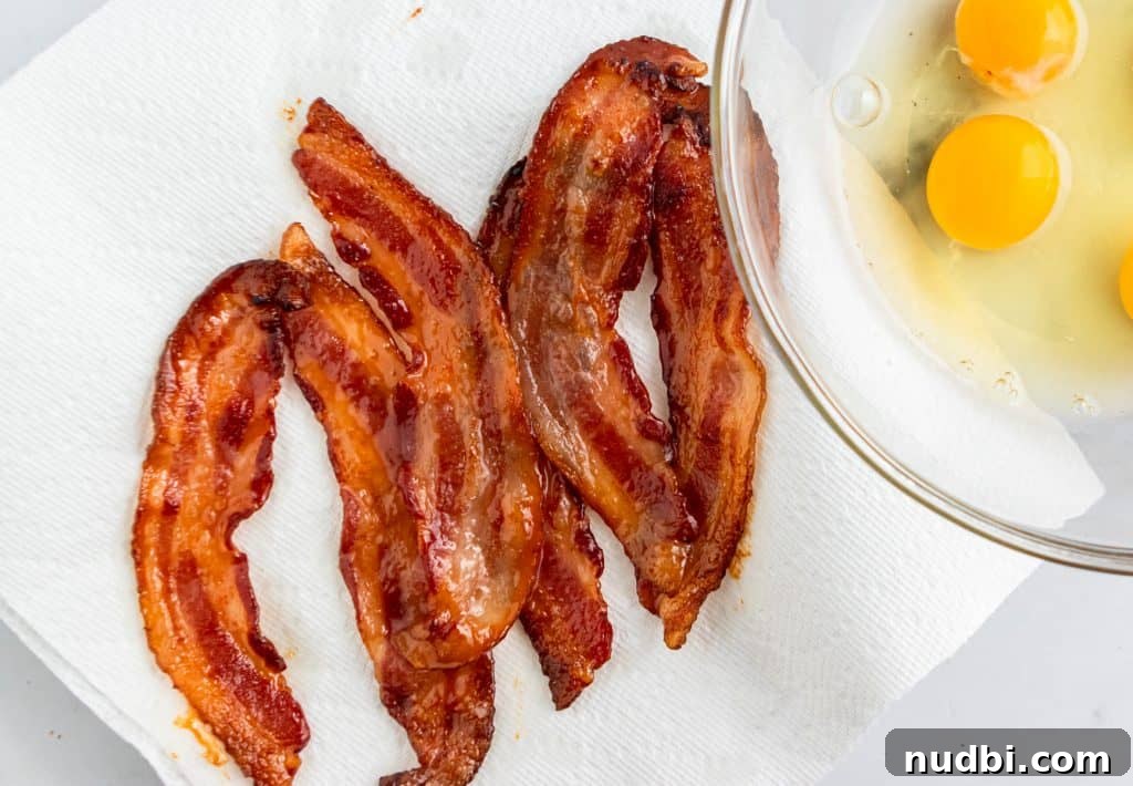 Maple Bacon French Toast Muffins Recipe for Brunch or Breakfast 4 strips of maple bacon sitting on paper towel.